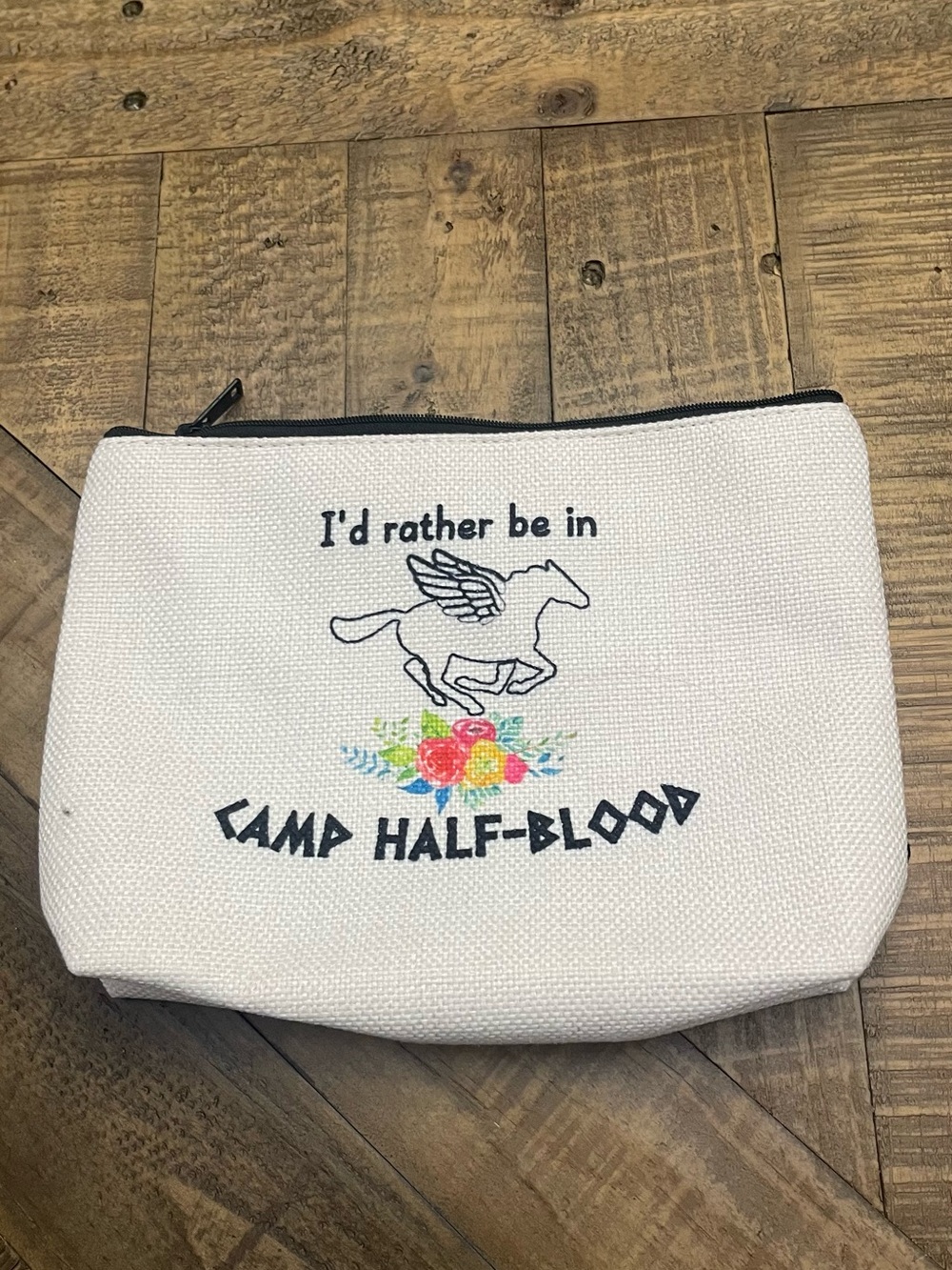 canvas makeup pouch featuring "Camp Half-Blood" embroidery from Percy Jackson